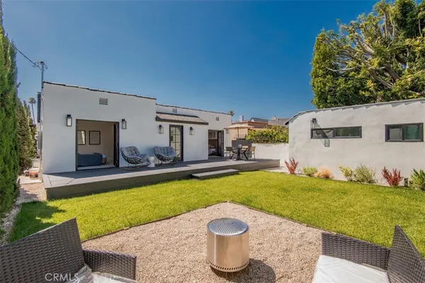 a view of a house with swimming pool and sitting area