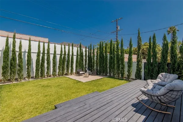 a view of a chairs and table in patio with wooden fence