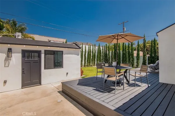 a view of a patio with a table chairs under an umbrella