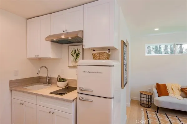 a kitchen with a sink a stove and a refrigerator