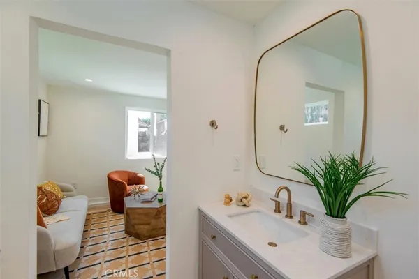 a bathroom with a sink mirror and vanity