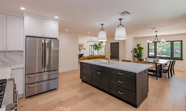 a kitchen with granite countertop a refrigerator and a sink