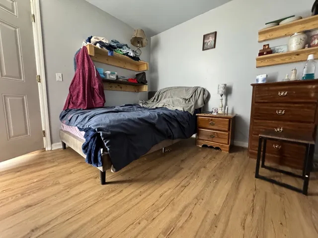 a bedroom with a bed and a dresser