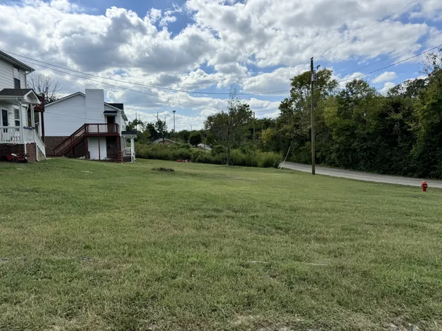 a view of a field of grass and trees