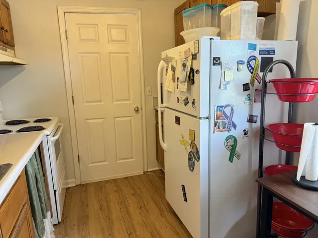 a white refrigerator freezer sitting inside of a kitchen