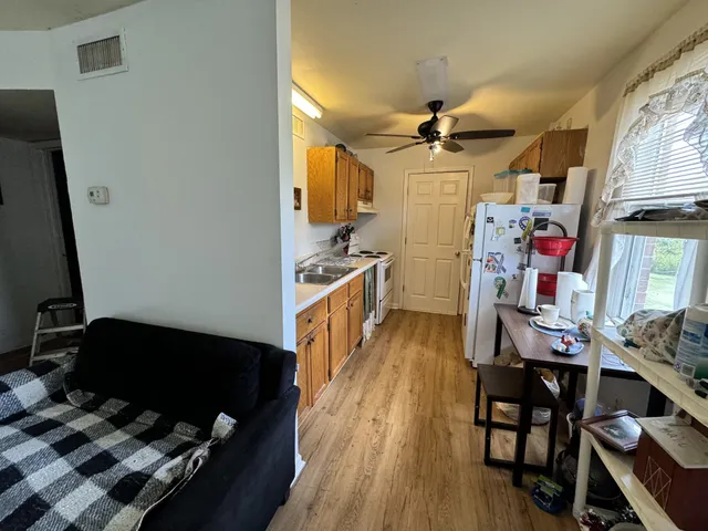 a view of a workspace with furniture and wooden floor