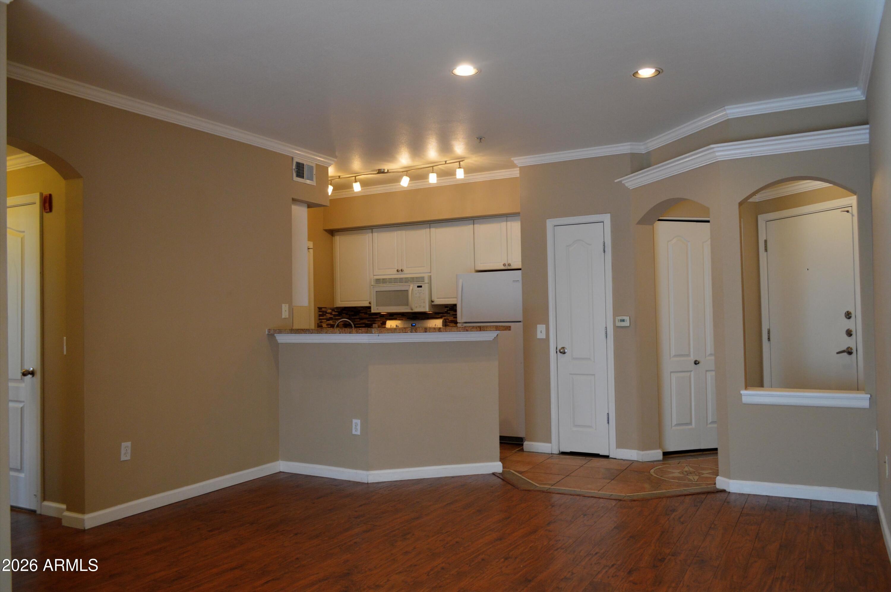 1701 East Colter Street, Unit 361 Phoenix, AZ 85016 - Photo 1 of 68 a view of a hallway with wooden floor and a bathroom