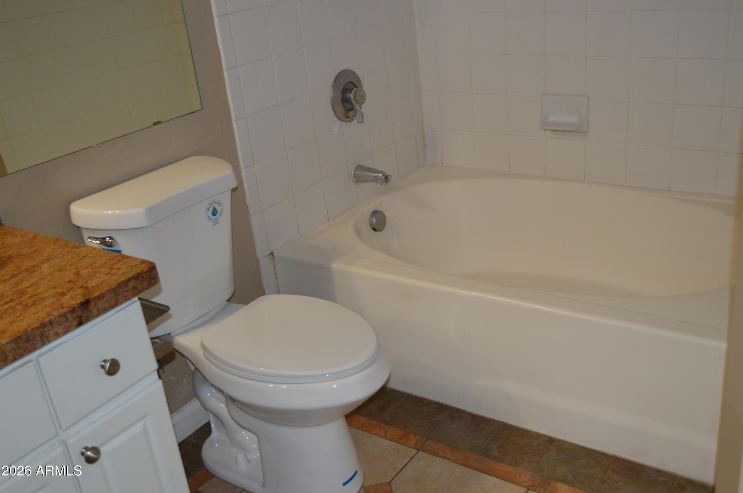 1701 East Colter Street, Unit 361 Phoenix, AZ 85016 - Photo 27 of 68 a bathroom with a granite countertop toilet and a bathtub