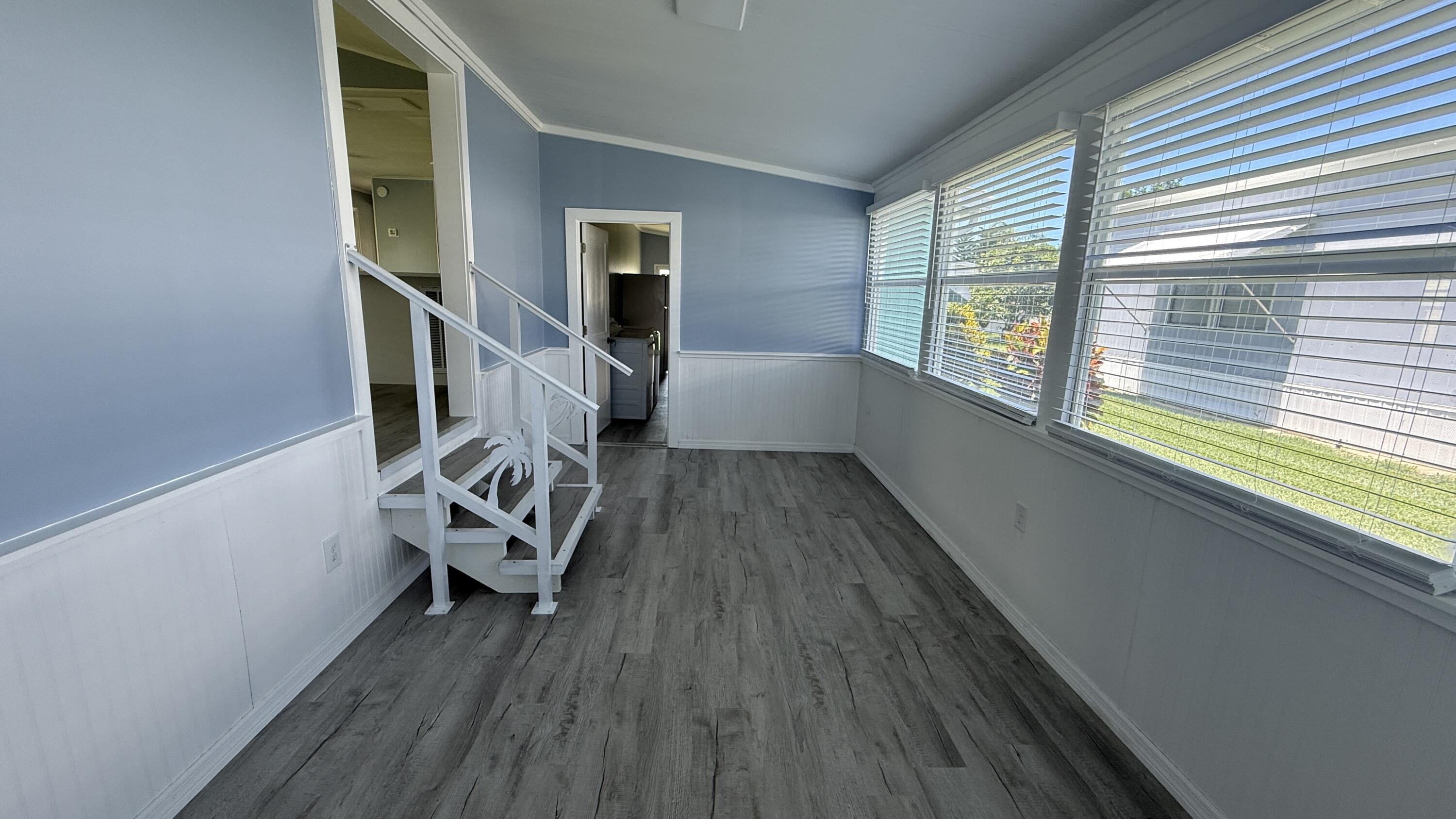6919 Southeast Congress Street Hobe Sound, FL 33455 - Photo 2 of 52 a view of an empty room with wooden floor and a window