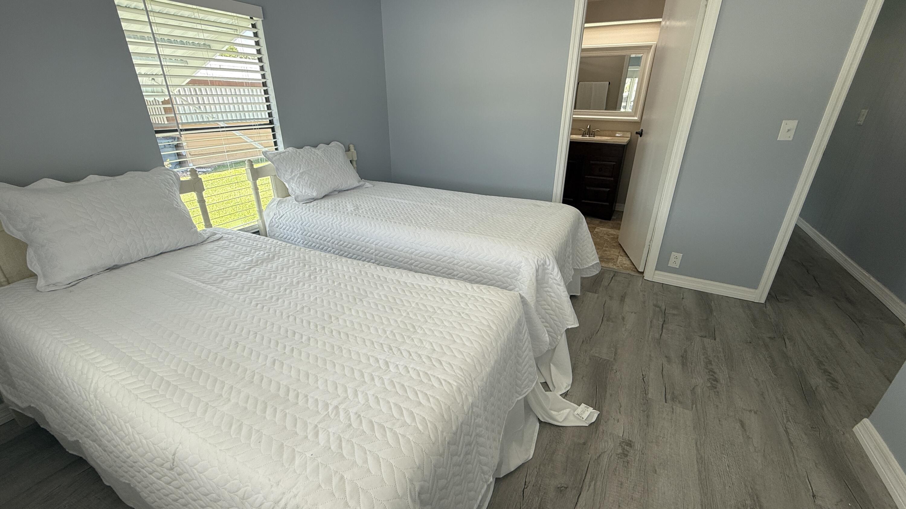 6919 Southeast Congress Street Hobe Sound, FL 33455 - Photo 23 of 52 a bedroom with a bed and a window