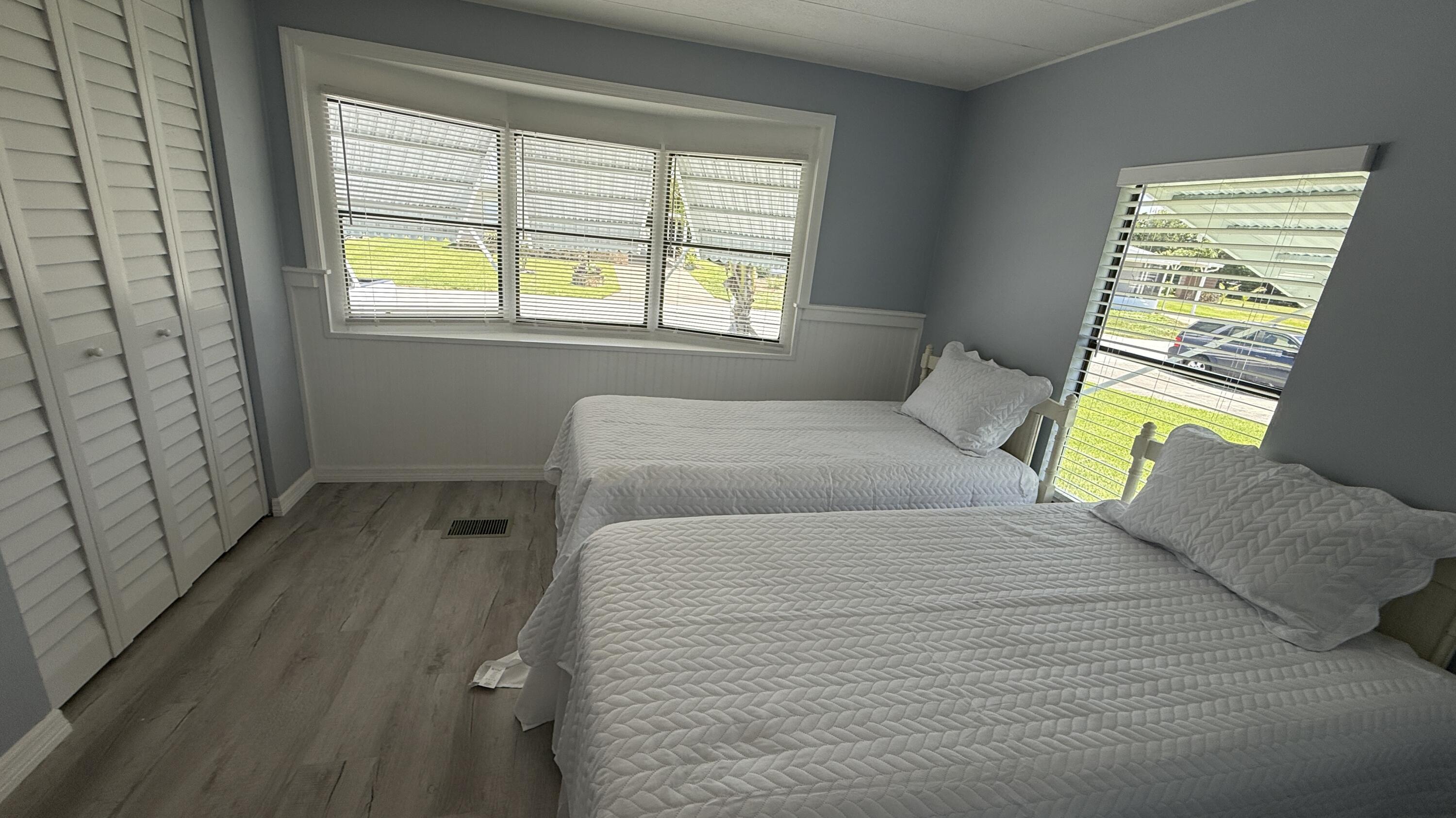 6919 Southeast Congress Street Hobe Sound, FL 33455 - Photo 24 of 52 a bedroom with a bed and a window
