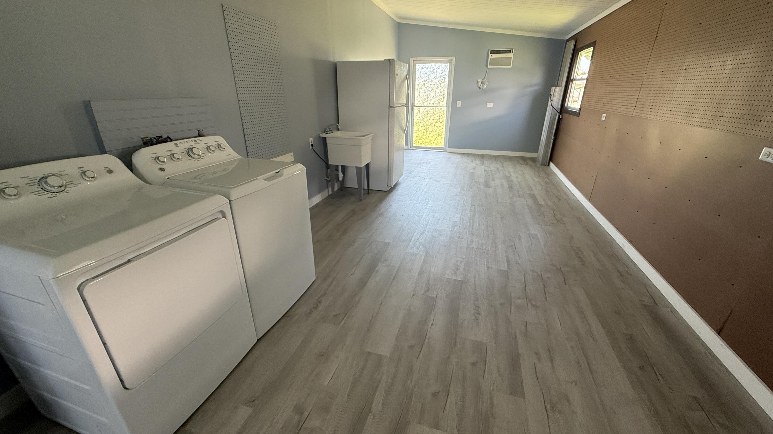 6919 Southeast Congress Street Hobe Sound, FL 33455 - Photo 27 of 52 a view of utility room with washer and dryer