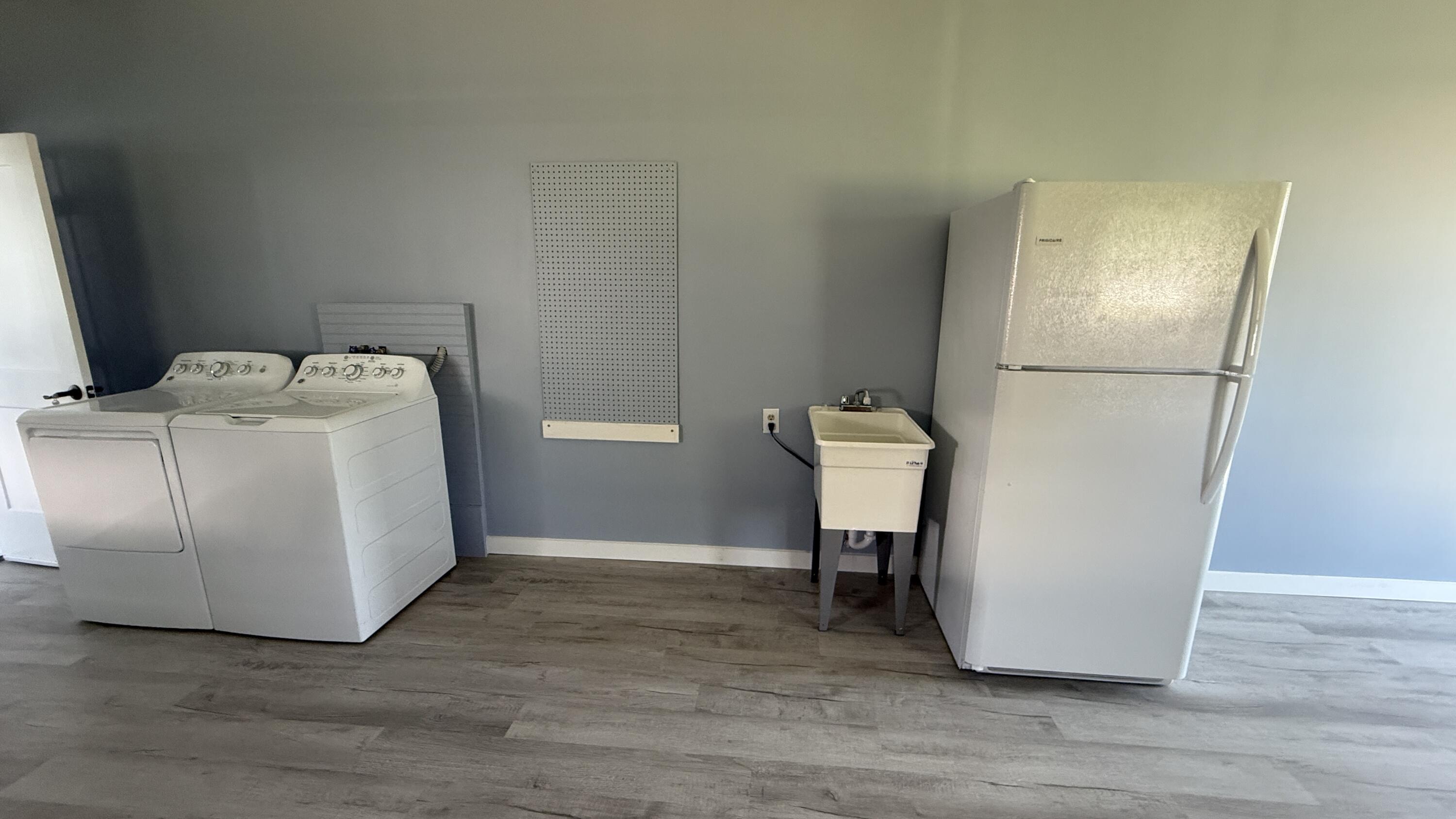 6919 Southeast Congress Street Hobe Sound, FL 33455 - Photo 31 of 52 a utility room with dryer and washer