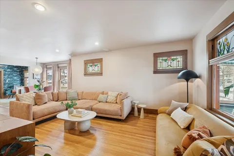 a living room with furniture and a wooden floor