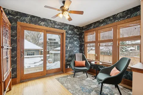 a living room with furniture and a floor to ceiling window