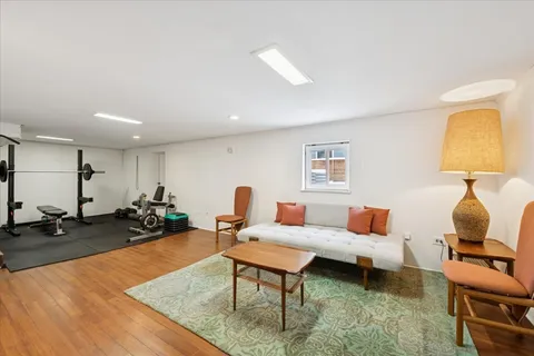 a living room with furniture and a lamp