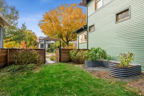 a front view of a house with a garden