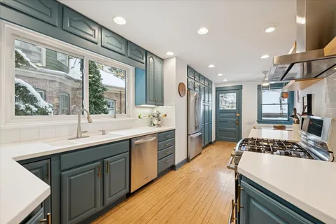 a kitchen with sink a stove and refrigerator