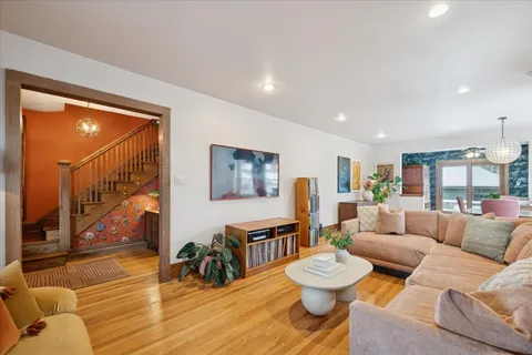 a living room with furniture and a wooden floor