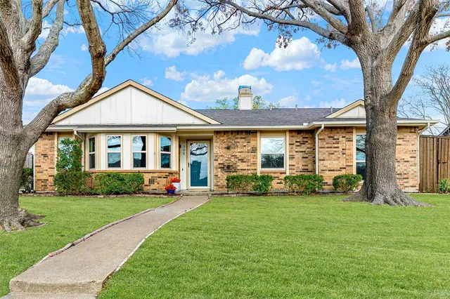 a front view of a house with a yard and porch