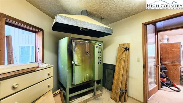 a view of a workspace with furniture and a window