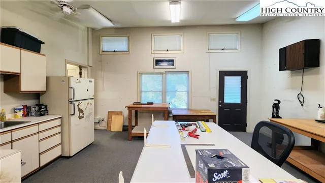 a kitchen with stainless steel appliances a stove a sink and white cabinets