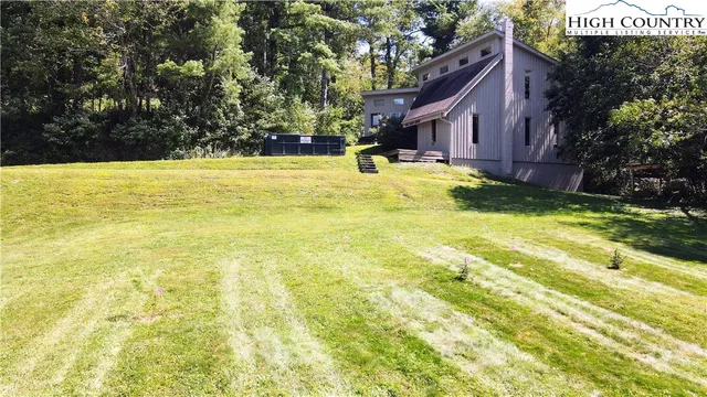 a swimming pool with trees in front of it