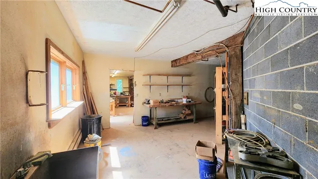 a bedroom with furniture and a window