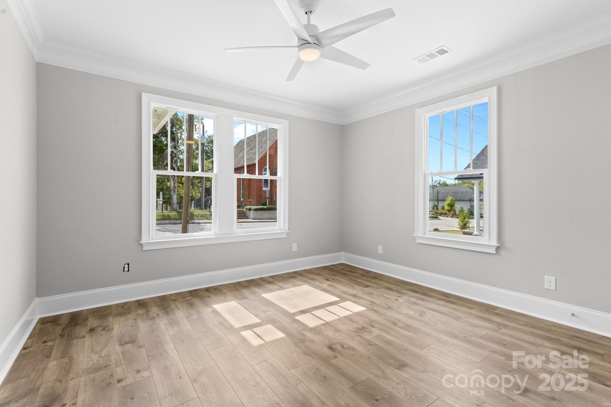 302 West Gay Street Lancaster, SC 29720 - Photo 12 of 26 a view of an empty room with a window and wooden floor