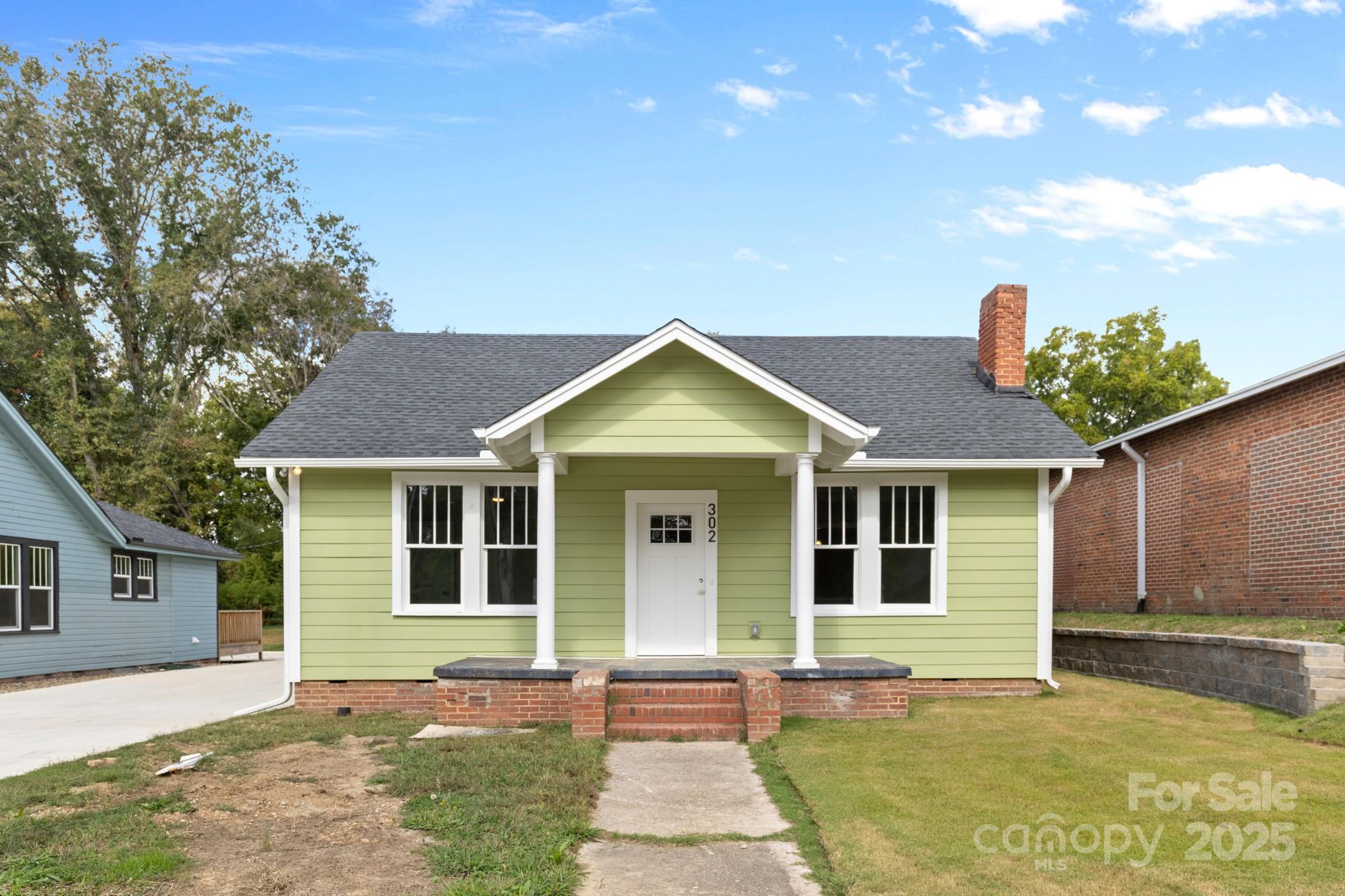 302 West Gay Street Lancaster, SC 29720 - Photo 2 of 26 a front view of a house with a yard and garage