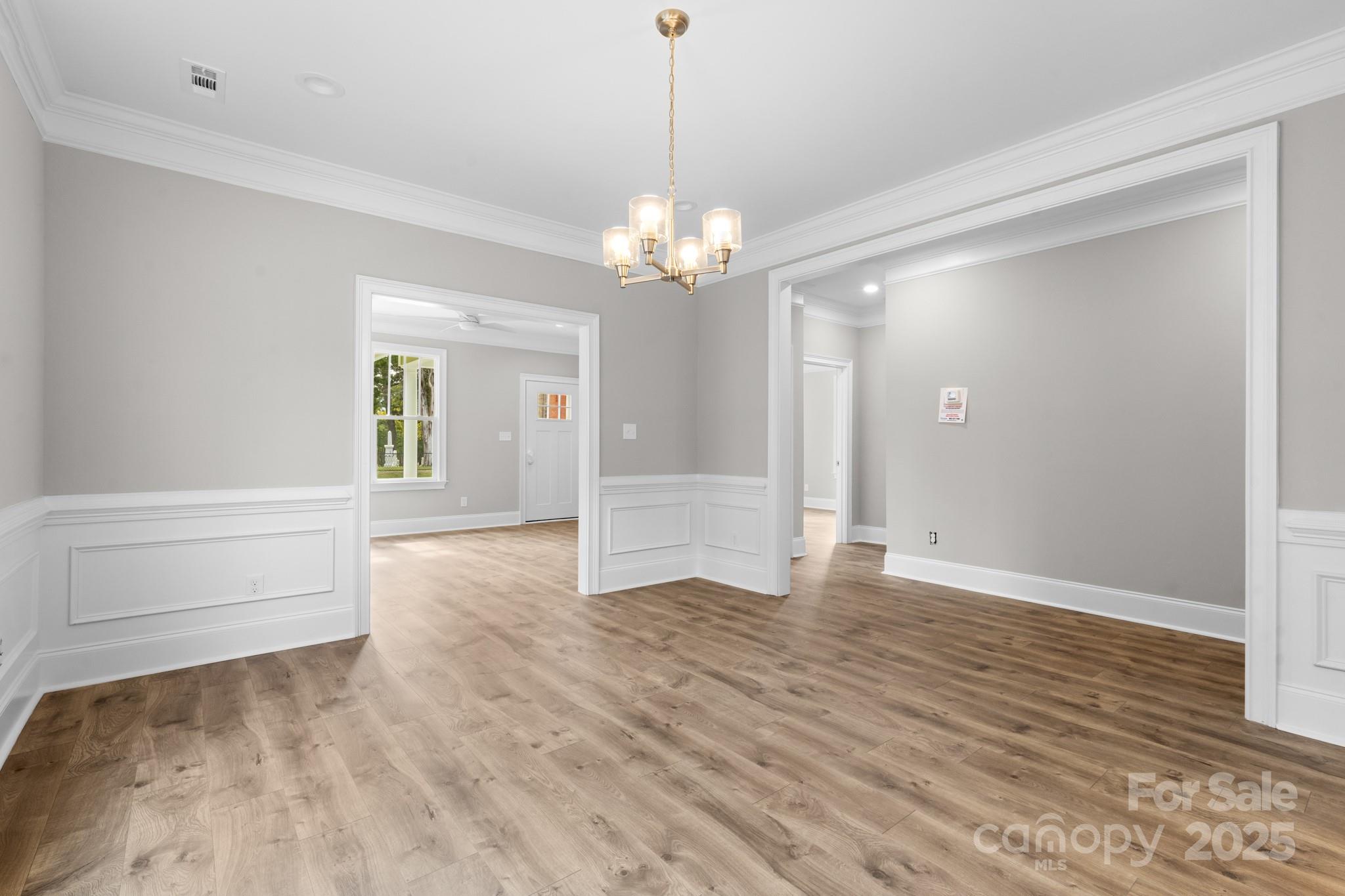 302 West Gay Street Lancaster, SC 29720 - Photo 8 of 26 a view of an empty room with window and chandelier fan