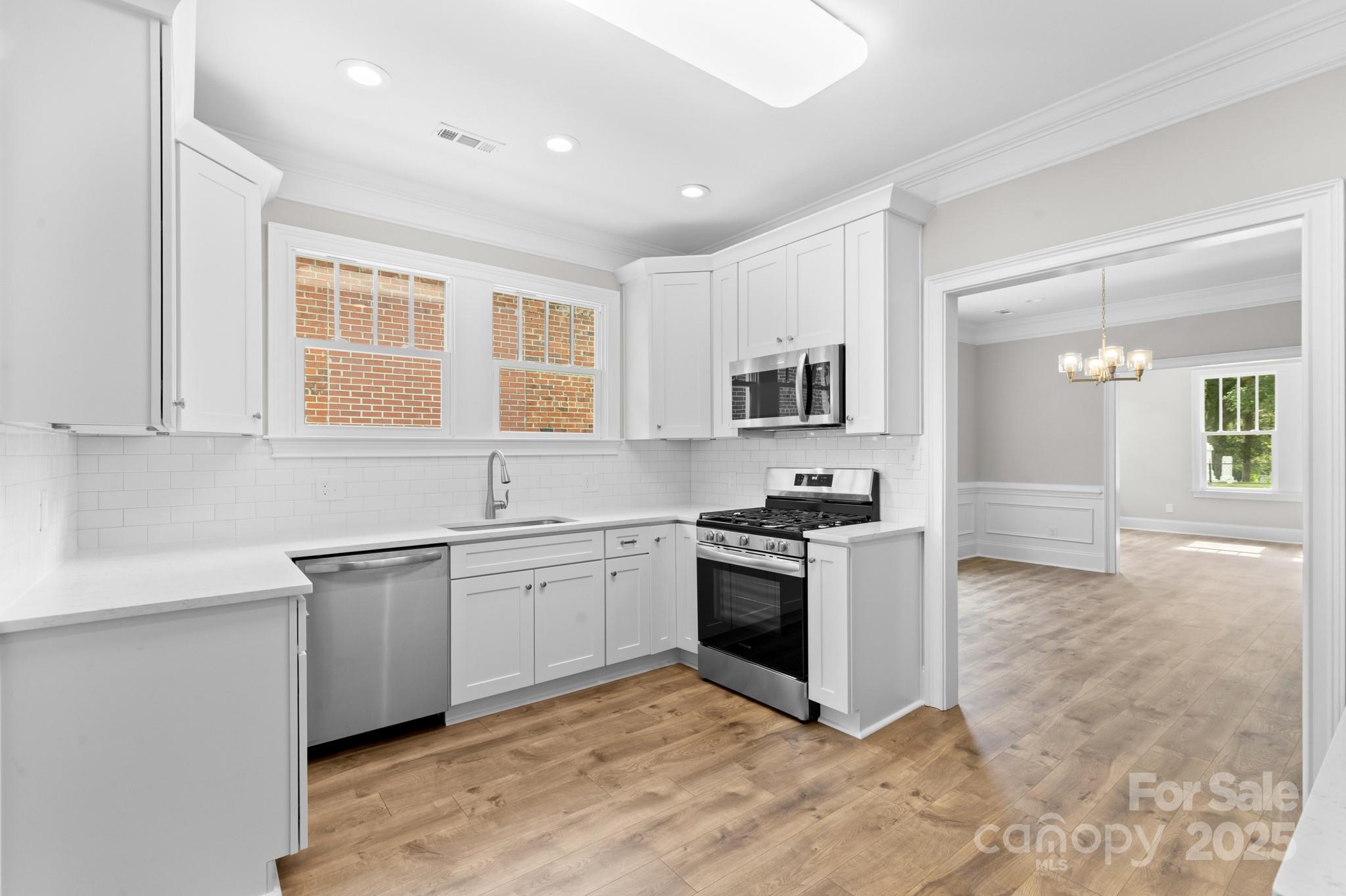 302 West Gay Street Lancaster, SC 29720 - Photo 9 of 26 a kitchen with stainless steel appliances granite countertop a stove a sink and a refrigerator