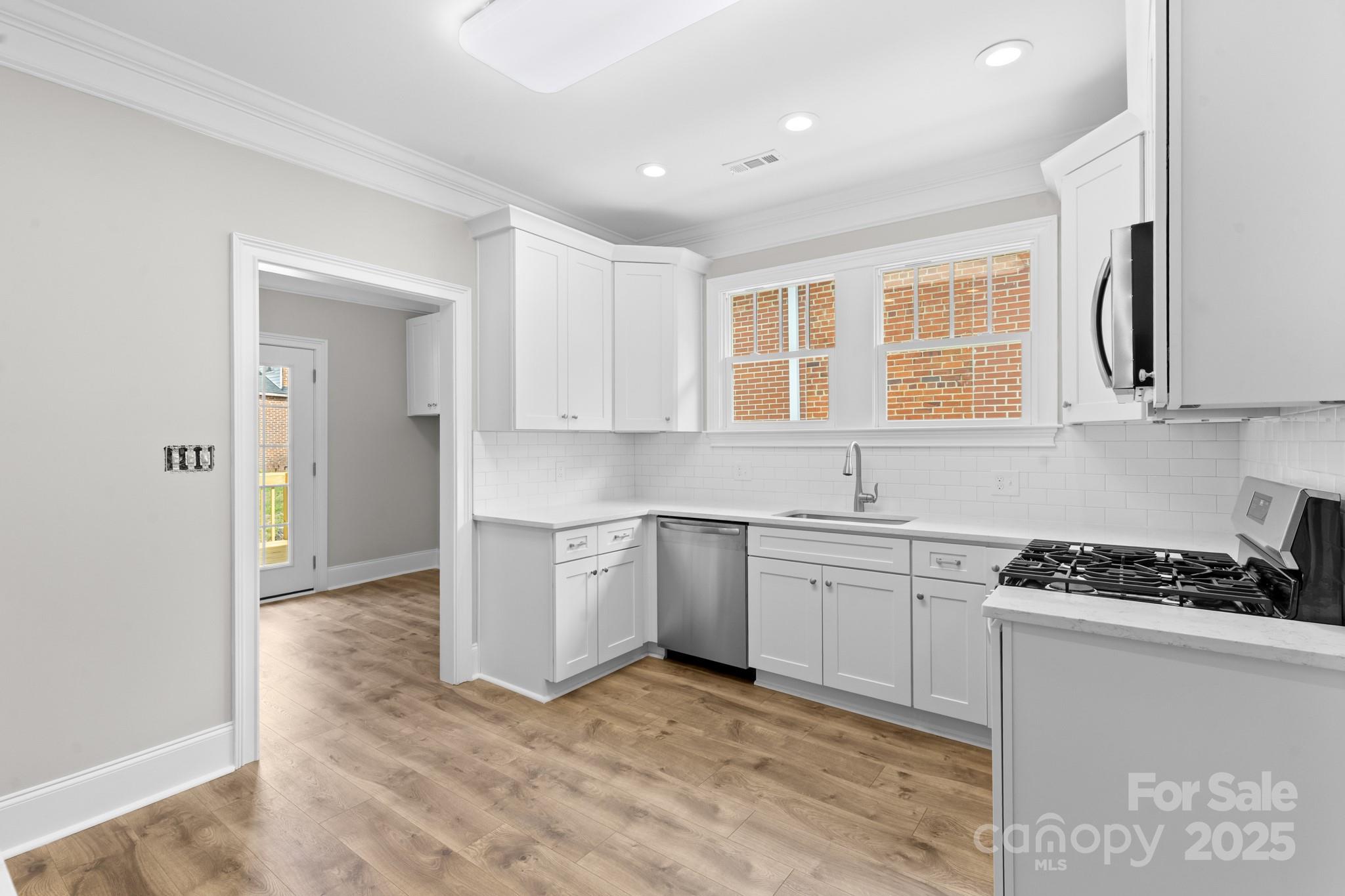 302 West Gay Street Lancaster, SC 29720 - Photo 10 of 26 a kitchen with stainless steel appliances granite countertop a stove and a sink