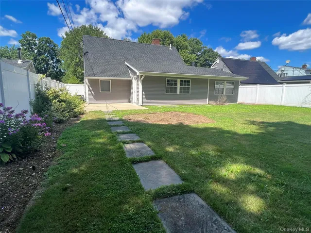 a view of an house with backyard space and garden