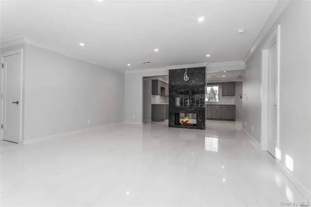 an empty room with furniture and natural light