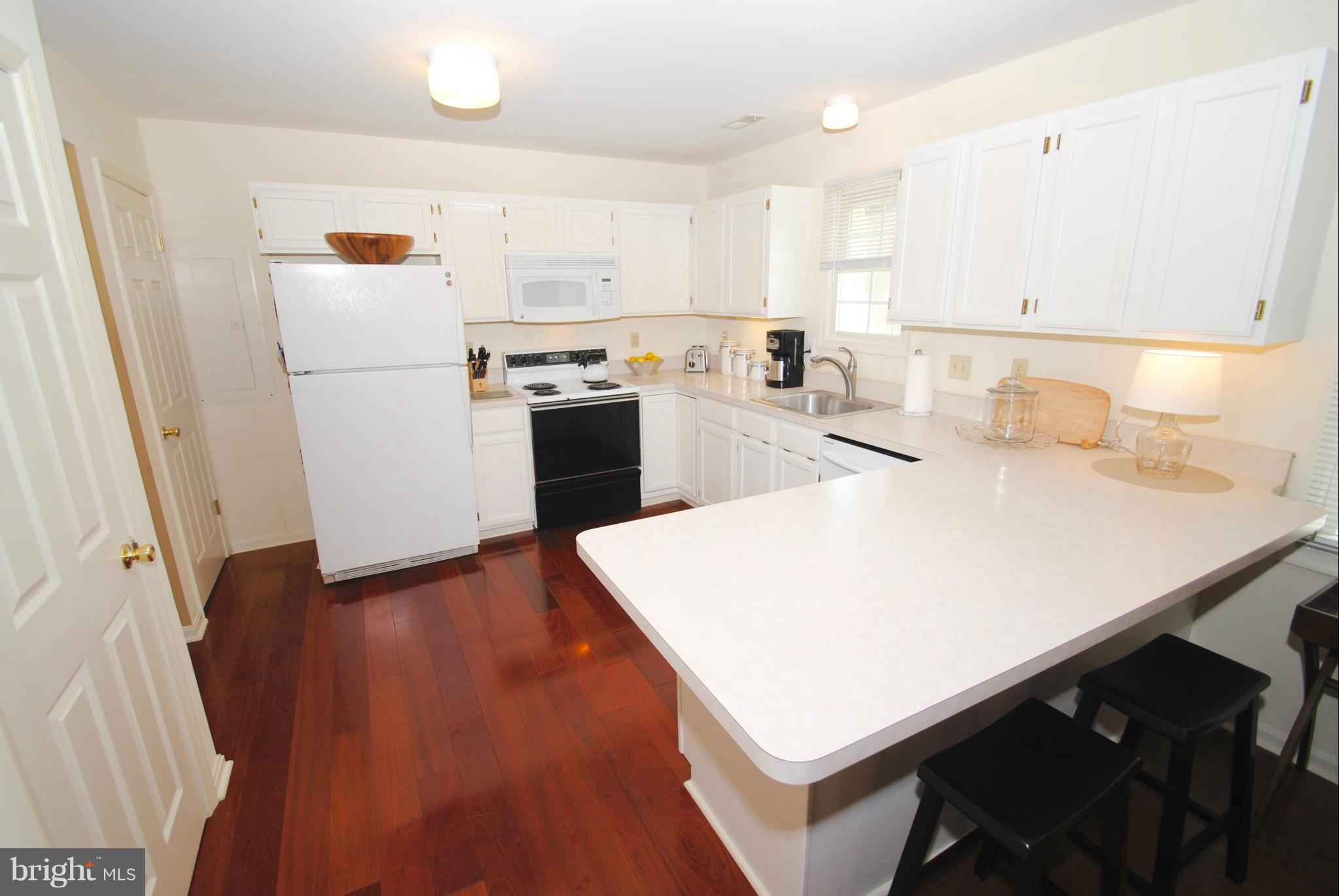1531 Mayfield Road Edgewater, MD 21037 - Photo 9 of 26 a kitchen with a sink a refrigerator and white cabinets