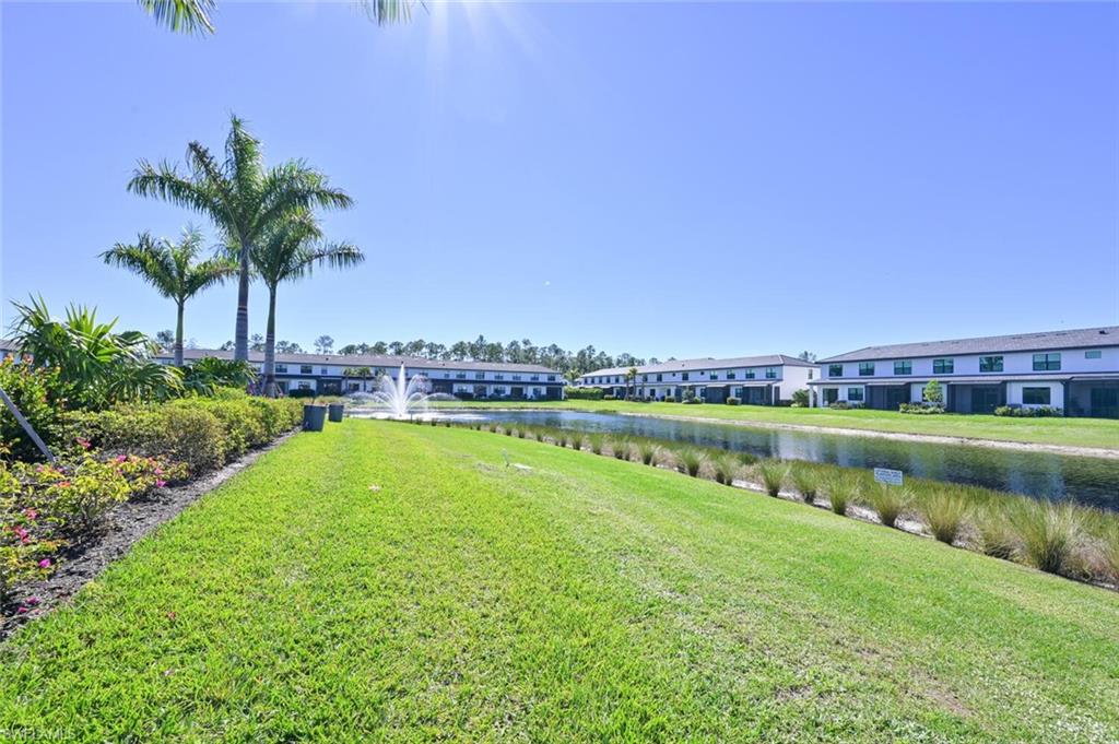 7611 Morgan Way Naples, FL 34119 - Photo 25 of 26 a view of a lake with a building in the background