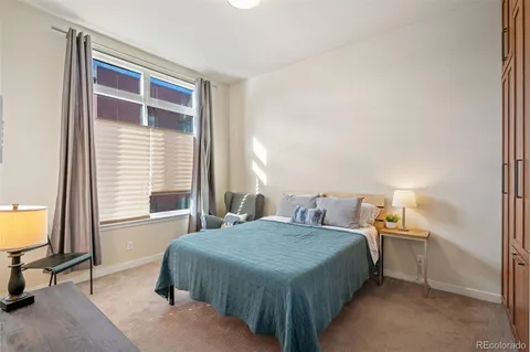 a bedroom with a bed and a table