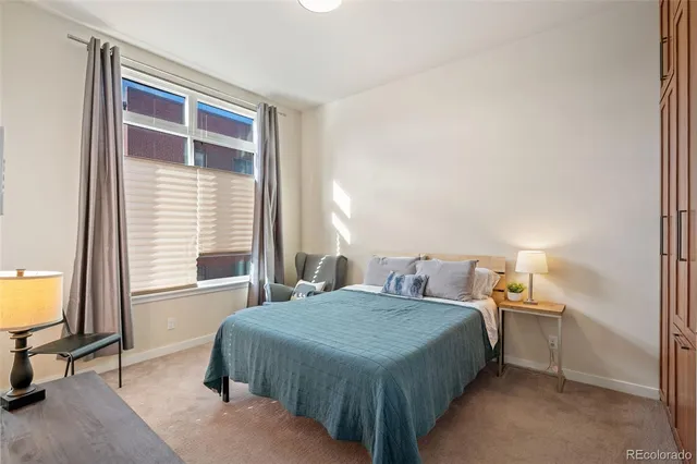 a bedroom with a bed and a table