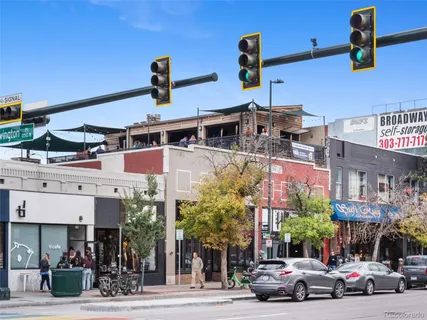 a view of street with shops and trees