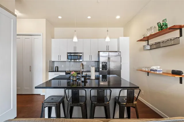 a kitchen with kitchen island a table and chairs in it