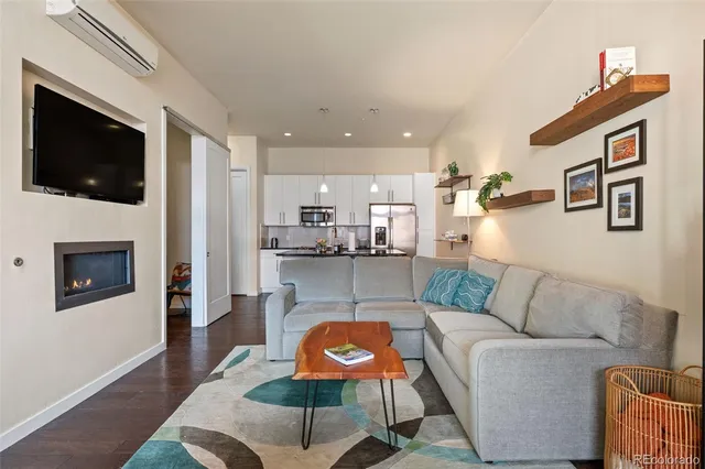 a living room with furniture a rug and a table