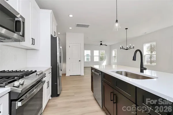 a view of an empty room with a window and a ceiling fan