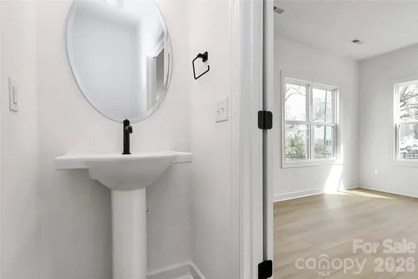 a white toilet sitting next to a bathroom sink