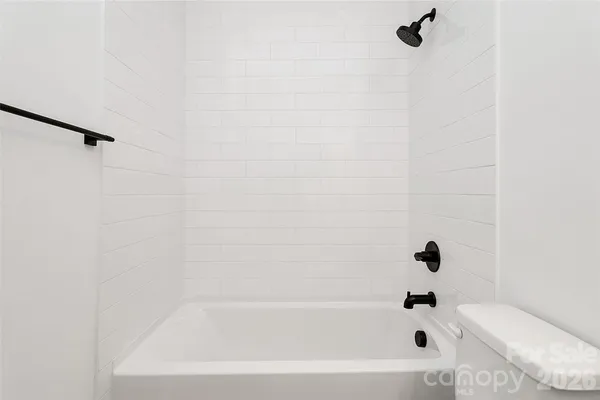a view of a livingroom with wooden floor and a large window