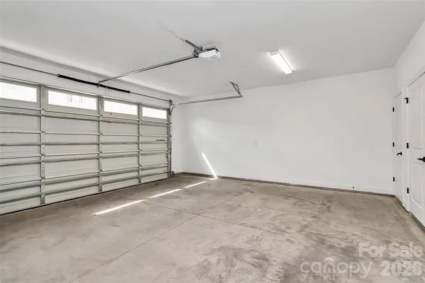 a view of an empty room and kitchen view