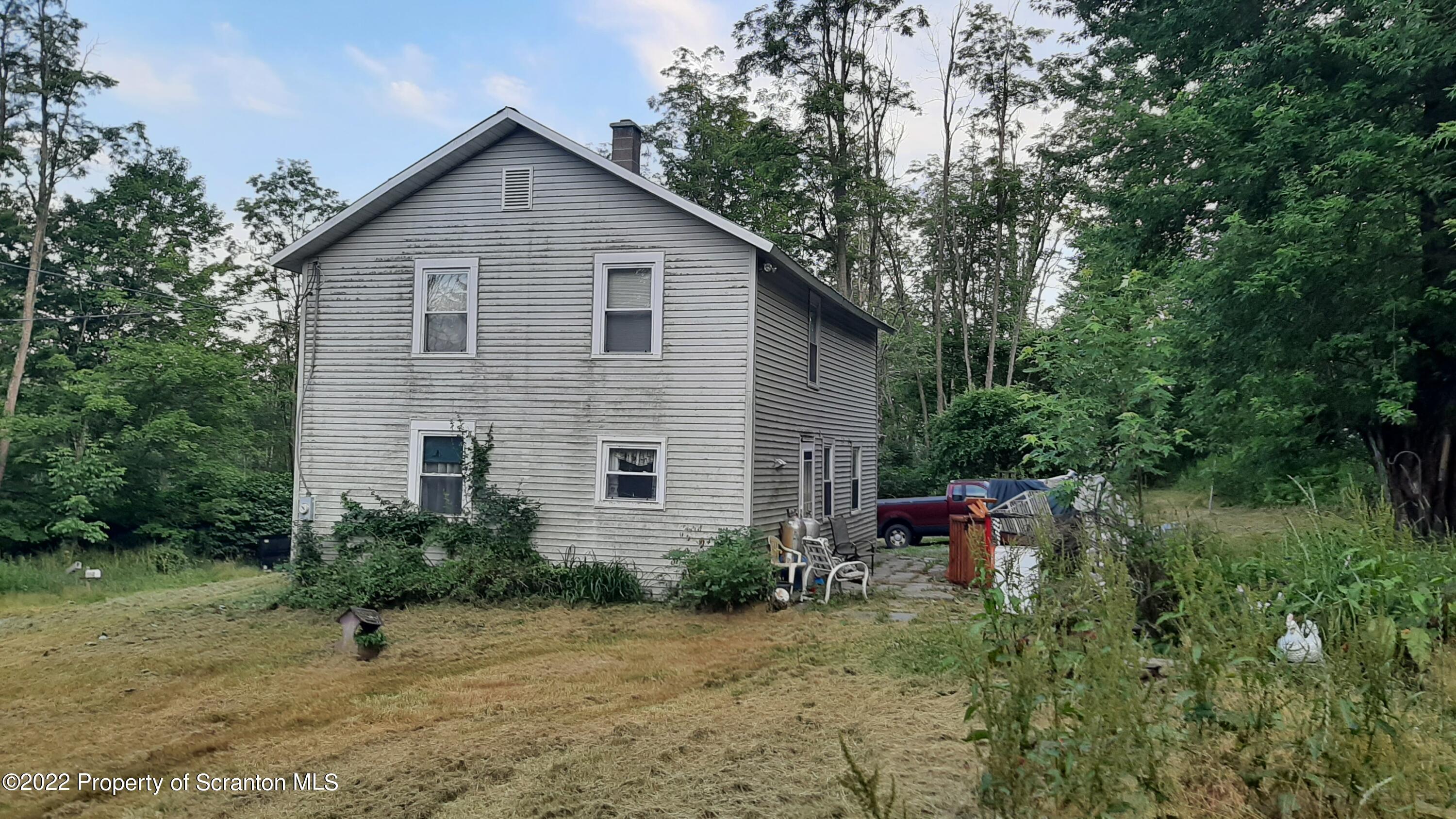 469 Bennett Road Hop Bottom, PA 18824 - Photo 3 of 25 a view of a house with yard and sitting area