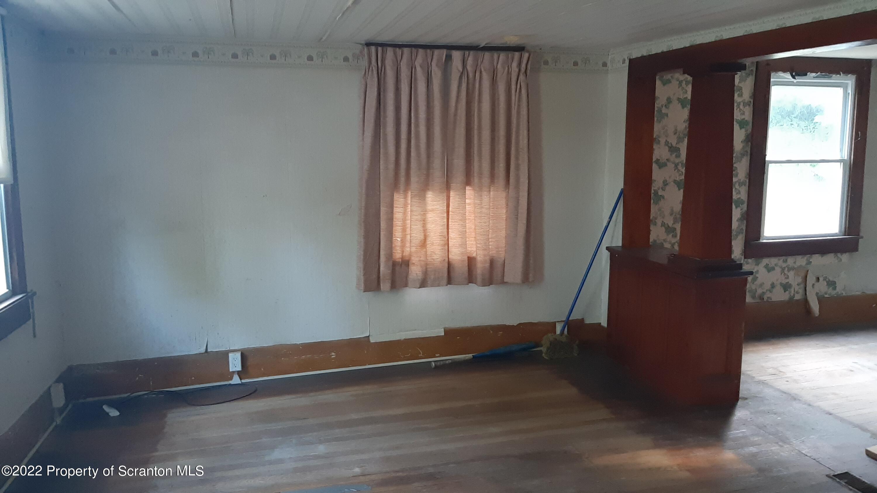 469 Bennett Road Hop Bottom, PA 18824 - Photo 7 of 25 a view of an empty room with wooden floor and a window