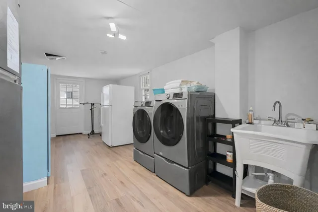 a utility room with sink dryer and washer