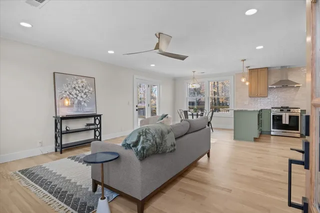 a living room with furniture and a wooden floor